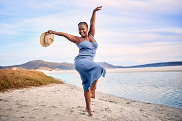 Portrait, excited and black woman dancing, beach and movement with happiness, tropical island or...