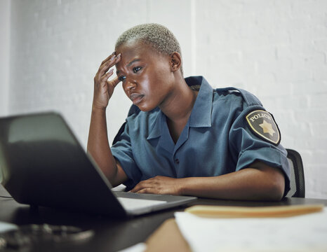Police, woman and headache from working with stress on computer or frustrated with case, report or anxiety in security. African, officer and tired from work on documents in office or station