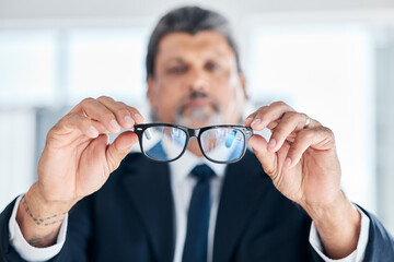 Man, hands and holding glasses at work for vision, bluelight security and cleaning lens. Closeup, bokeh and a mature corporate employee with eyewear for eyes support, frame and help with eye care