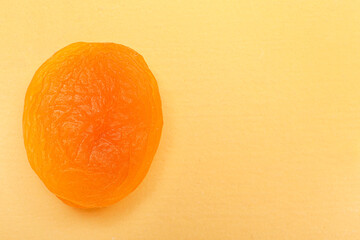 Tasty dried apricot on orange background