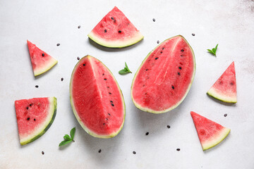Composition with different pieces of ripe watermelon on light background