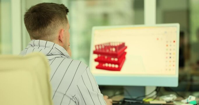 Process engineer working on personal computer, monitor screen showing CAD software with 3D prototype. Man 3d modeling on computer