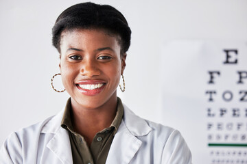Happy, optometry and portrait of a black woman at a clinic for healthcare, eye care and expert. Smile, hospital and headshot of an African doctor or optometrist in an office for a vision check
