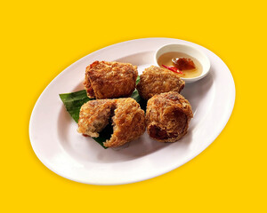 Deep Fried Ricefield crab meat roll, on white plate, isolate, yellow background