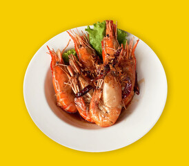 Fried River Prawn with Tamarind Sauce, Thai food, isolated, on the white plate, yellow background
