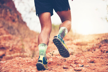A man Runner of Trail . and Close up of an athlete's feet wearing sports shoes for trail running in the mountains