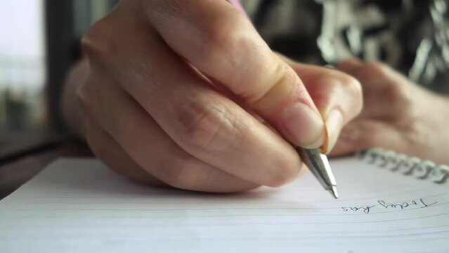 close up of a woman hand taking handwritten notes
