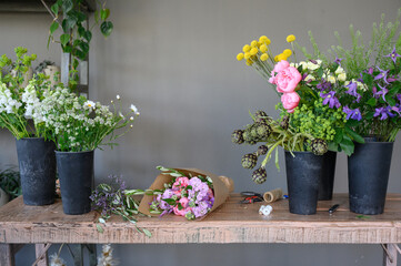Potted colorful flowers on wooden table