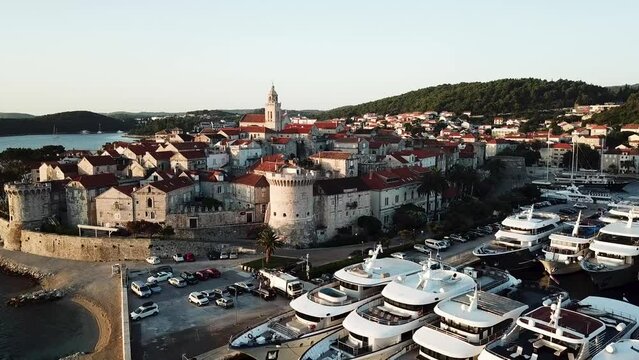A drone aerial of a beautiful town Korcula at sunrise. A famous sland in the Adriatic Sea. 4K