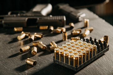 spent pistol casings on the dark table and pistols