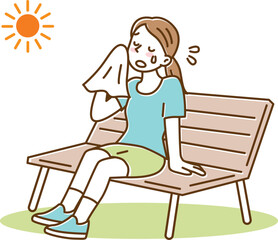 暑い夏、ハンカチで汗を拭いてベンチで休憩する若い女性
