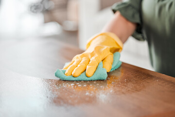 Hands, cleaning and bacteria on a wooden table for hygiene, disinfection or to sanitize a surface...