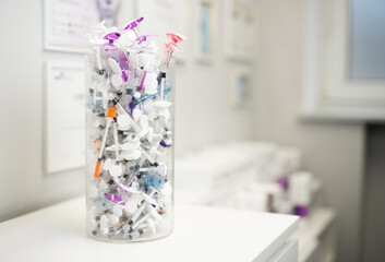 many syringes for cosmetic surgery in a large transparent box