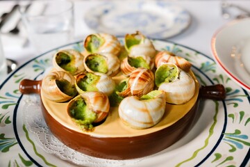 A plate of garlic and parsley butter escargot at a French bistro in Circular Quay, Sydney — New...