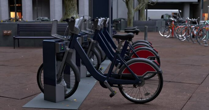 Row of Green bicycles for rent. Electric bicycle charging station. Shared electric bikes parked on city street