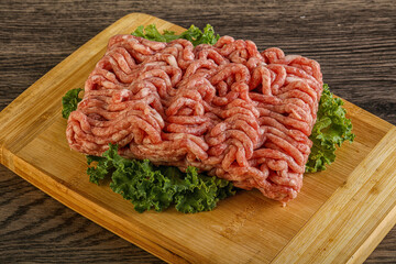 Raw pork minced meat over board