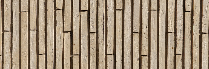 Panoramic image. Wall of beige vertical clinker bricks