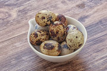 Raw quail eggs heap in the bowl