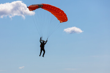 Parachute in the sky. Skydiver is flying a parachute in the blue sky
