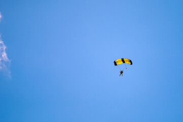 Parachute in the sky. Skydiver is flying a parachute in the blue sky