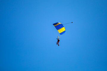 Parachute in the sky. Skydiver is flying a parachute in the blue sky