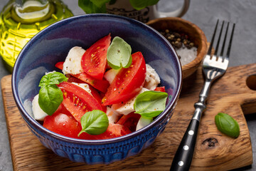 Caprese salad with ripe tomatoes, mozzarella and garden basil
