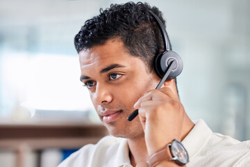 Focus, serious and male call center consultant working on online consultation in the office....