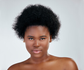 Face, skincare and serious black woman in studio isolated on a white background. Portrait, beauty...