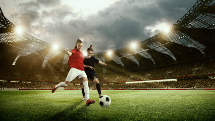 Two competitive women, football players in motion during match, game, dribbling ball at 3d arena....