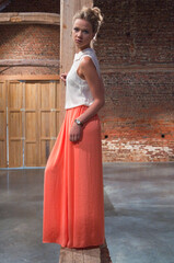 woman in dress standing near the wall