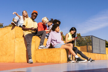 Multiracial group of young friends bonding outdoors