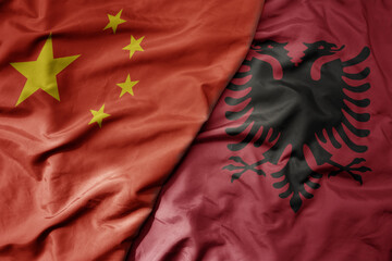 big waving national colorful flag of china and national flag of albania .