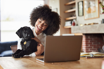 Home, dog and woman with a laptop, smile and bonding with connection, playing and love in the...