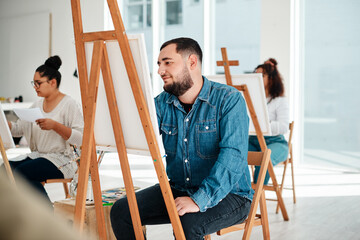 Art is a form of expression. Cropped shot of a diverse group of artists sitting together and painting during an art class in a studio.