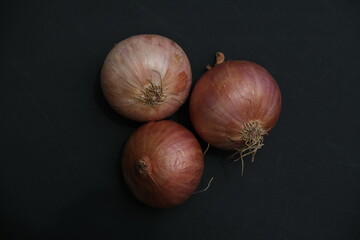 Three Onions isolated on black background