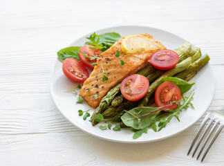 Baked Delicious salmon, green asparagus on  plate