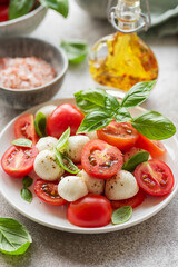 Obraz na płótnie Canvas Caprese salad with tomatoes, mozzarella and basil.