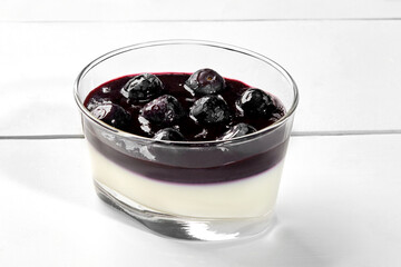 Panna cotta with blueberries and lavender coulis in glass