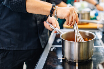 Chef cook hand cooking food at the restaurant kitchen