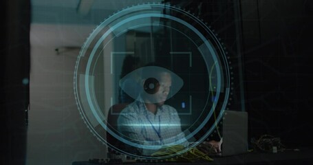 Animation of eye retina scanner over african american male engineer using laptop at server room - Powered by Adobe