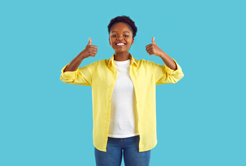 Joyful young ethnic woman giving two thumbs up recommending or approving great choice. African...