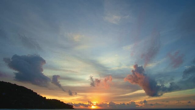 .Timelapse stunning the sun shining through the clouds at the horizon..Scene of colorful light through the clouds above the ocean..Gradient color. Sky texture, abstract nature background.