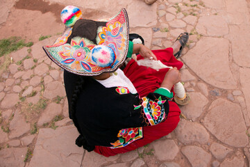 Indigenous woman working on the elaboration of textile handicrafts in a community on Lake Titicaca,...
