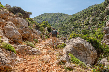Tourist walking the hiking trail from Stavros to Katholiko Bay and Gouverneto Monastery, Stavros,...