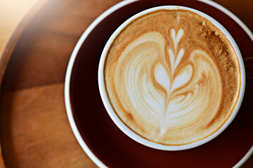 high angle view of coffee cup on wood grain table Drinking Concept: Hot Coffee, Latte, Espresso, Cappuccino