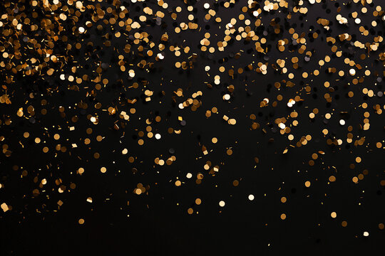  Golden confetti on black background