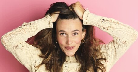 Happy woman looking camera shocked surprised say wow put hands on face, touch her hair. Wow, it is awesome. Surprised girl face. Close up of shocked woman face expression isolated on pink background.