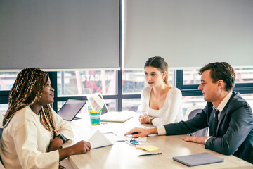 Business analyst team using laptop for financial insight with Fintech paper for data analysis dashboard. Creative and analytic brainstorming for marketing plan strategy system idea. Prodigy teamwork