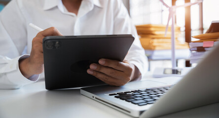 Business man using computer on CO2 emission reduction concept with global warming icon. along with...