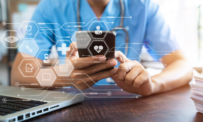 Medical Technology Concepts The doctor is working on a smartphone and a digital tablet computer in a modern office in the morning at the desk